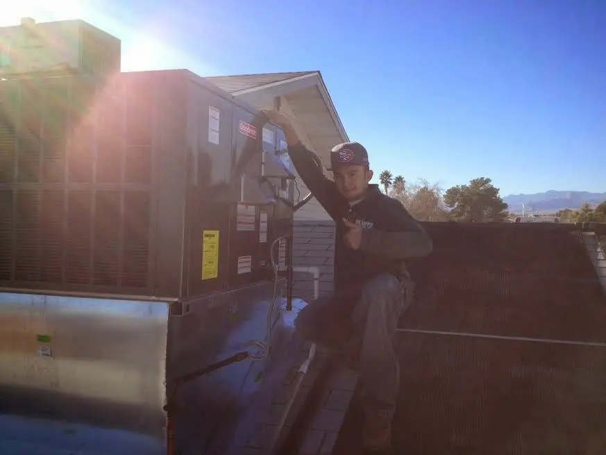 HVAC technician performing Air Duct Repair on a rooftop unit in Buffalo Grove
